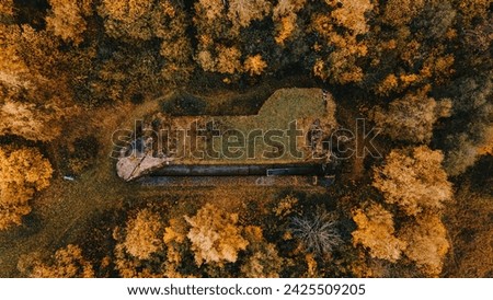 Drone view of colourful forest with abandoned artilery concrete bunker in mountains. Orlicke hory, Czechia