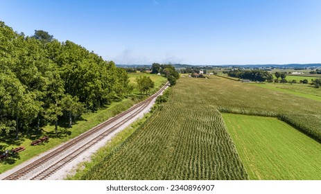 A Drone View of Corn Fields, Pastures and Farms Next to a Rail Road Track on a Sunny Summer Day