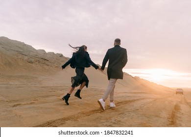 Drone view of a couple in love on the sand dunes