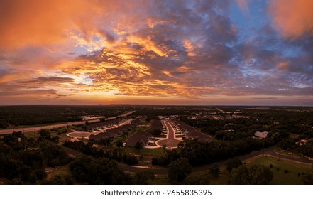 Drone view of dramatic sunset seen above over-55 community near Georgetown in Texas