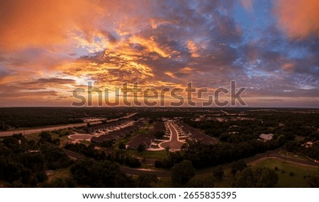 Drone view of dramatic sunset seen above over-55 community near Georgetown in Texas