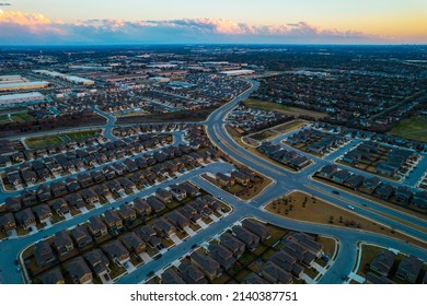 Drone view during perfect Golden hour sunset over millions of houses and rooftops in Austin , Texas , USA Suburb Neighborhoods