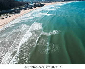 drone view of empty coast , waves crashing beach amazing nature in winter day