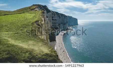 Drone view of the famous Etretat Cliffs at Tilleul beach with people chilling out in Etretat Normandy France