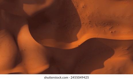 A drone view of golden Sandy desert texture lines and pattern. Aerial top the surface at the Sand Dunes Abstract landscape with desert dunes on a sunny day - Powered by Shutterstock