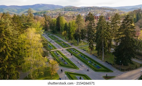 Drone View Of Green Space City Park Aerial Drone View High Above Vrnjacka Banja. Top View Aerial Photo From Flying Drone Of A City Park With Walking Path And Green Zone Trees.