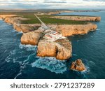 Drone view of the Lighthouse of Cabo de Sao Vicente in Sagres, Algarve, Portugal, at sunset with open ocean and Atlantic ocean