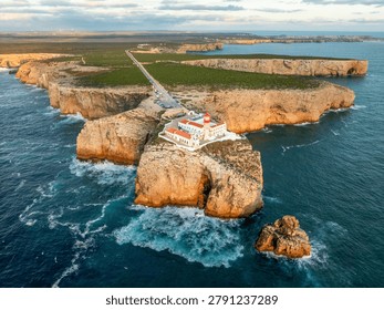 Drone view of the Lighthouse of Cabo de Sao Vicente in Sagres, Algarve, Portugal, at sunset with open ocean and Atlantic ocean