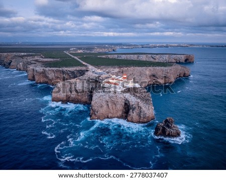 Drone view of the Lighthouse of Cabo de Sao Vicente in Sagres, Algarve, Portugal, at evening with ocean texture and Atlantic ocean