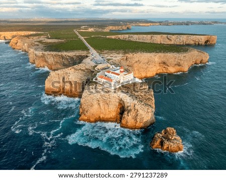 Drone view of the Lighthouse of Cabo de Sao Vicente in Sagres, Algarve, Portugal, at sunset with open ocean and Atlantic ocean