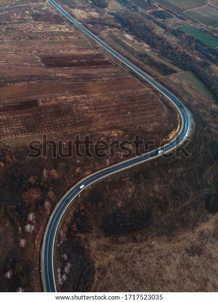 drone view on curve of\
road in fields