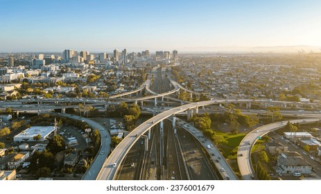 A drone view over the freeway cypress in Oakland, California during sunset with the downtown in the background. - Powered by Shutterstock