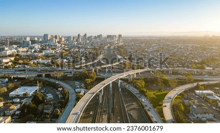A drone view over the freeway cypress in Oakland, California during sunset with the downtown in the background.