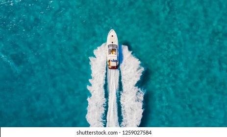 Drone View Overhead Driving Fast Over Turquoise Water.