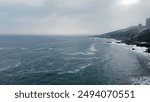 Drone view of the Pacific Ocean in Viña del Mar, Chile, showcasing the stunning coastline, crashing waves, and expansive blue waters