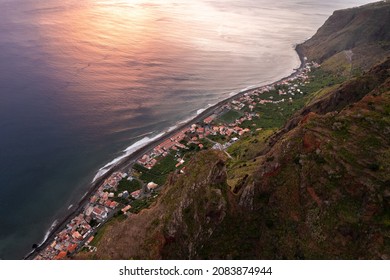 Drone View Of Small Settlement With Residential Houses Located Along Shore Near Sea In Paul Do Mar On Madeira In Evening