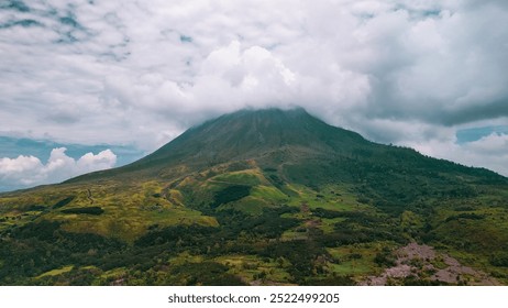 Drone view of a vulcanic mountain with a cloudy sky