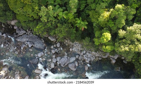 A Drone View Of Water Running Through Rocks In The Rainforest