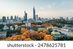 A drone view of the Zifeng Tower in Nanjing, Jiangsu, China in autumn with colorful trees and cityscape