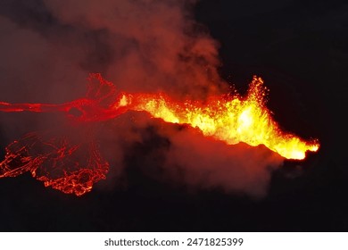 A drone's eye view captures the explosive spectacle of a lava river's fiery dance, painting the landscape with molten intensity.