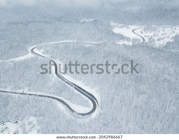 Drones\
Eye View - winter winding road from the high mountain pass in South\
Russia. Great road trip trough the dense\
woods.