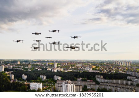 Drones fly over the city's houses. Urban landscape with drones flying over it,  flying over the city.