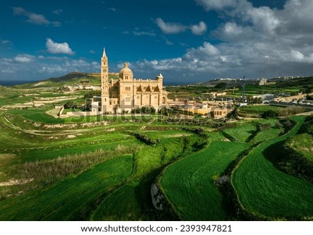 A drone's gaze captures The Sanctuary of Ta’ Pinu in Gozo, Malta—a revered pilgrimage site with spiritual significance.