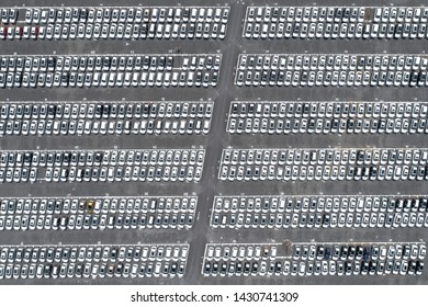 Drones overshoot large car parking lot densely arranged factory new car