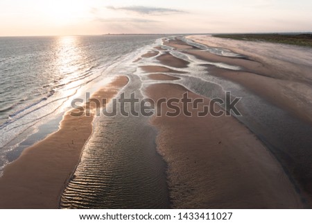 Drones View over the sandy beach and tidal channels of the island Juist in the North Sea in summer.