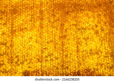 Drop of bee honey drip from hexagonal honeycombs filled with golden nectar, honeycombs summer composition consisting of drop natural honey, drip on wax frame bee, drop of bee honey drip in honeycombs