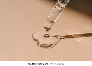A drop of cosmetic oil falls from the pipette - Shutterstock ID 1987870547