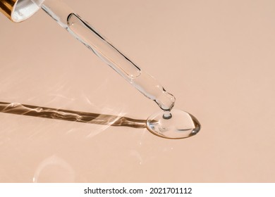 A drop of cosmetic oil falls from the pipette - Shutterstock ID 2021701112