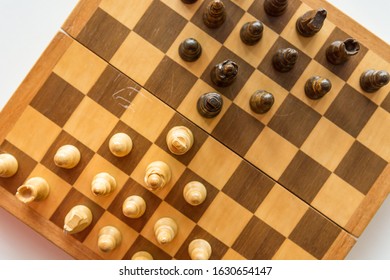 Drop down view of a chess board with wooden figures.