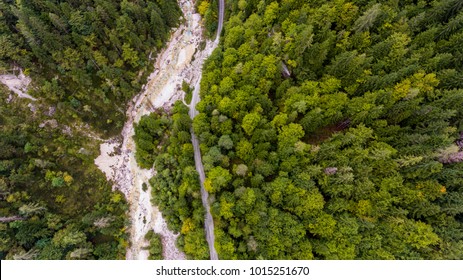 Drop down view of river bed running through a forest.