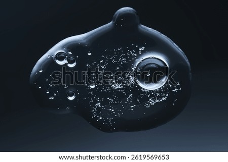 A drop of gel serum with bubbles. The texture. View from below.
