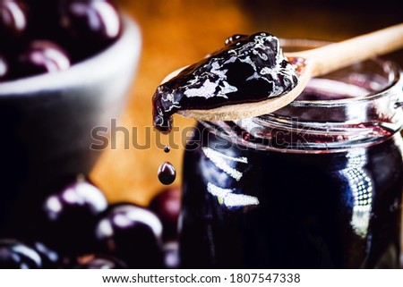 drop of jam dripping from the spoon. Brazil grape jelly, called jaboticaba or jabuticaba