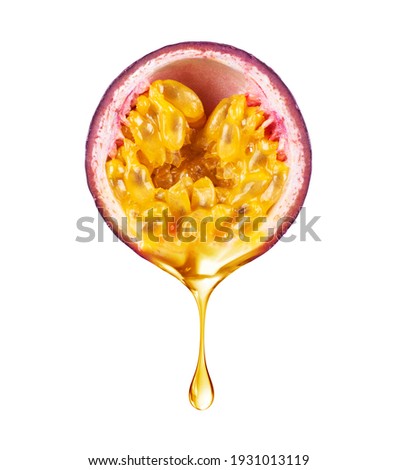 A drop of juice drips from half a passion fruit closeup isolated on white background