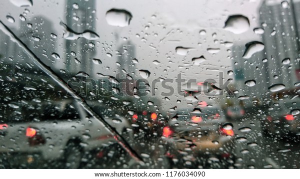 A drop of rain on the car window. Rain water
falling on the background of a glass surface, Abstract background.
Selective focus. 