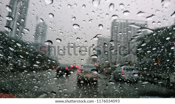 A drop of rain on the car window. Rain water
falling on the background of a glass surface, Abstract background.
Selective focus. 