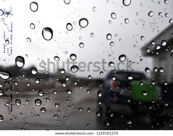 Drop of rain on the car\
window.