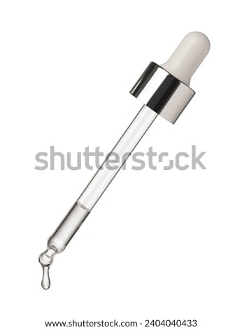 Drop of serum falls from glass pipette on white background