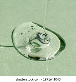 A drop of transparent cosmetic gel on a green background. - Shutterstock ID 1991641043