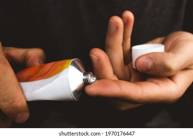 A drop of transparent gel on the finger of a guy's hand in a close-up - Shutterstock ID 1970176447