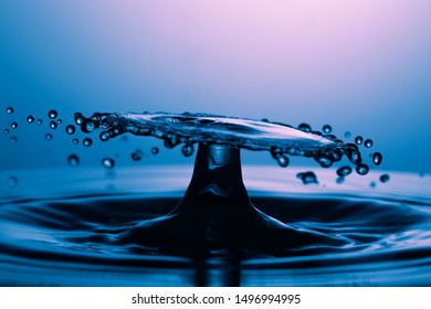 drop of water falling down in the water macro photo 