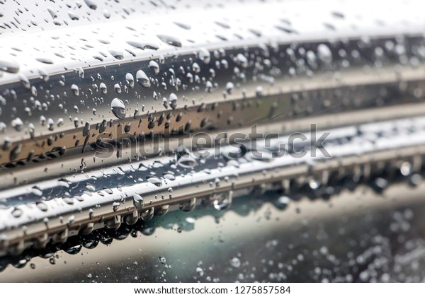 Drop of water on car background, water droplets\
wet in the rainy season