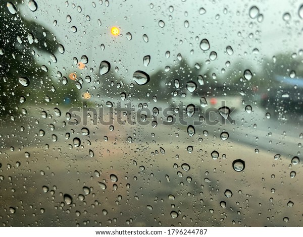 Drop of water on the car window, Heavy rain, The\
use of car in the rainy\
season.