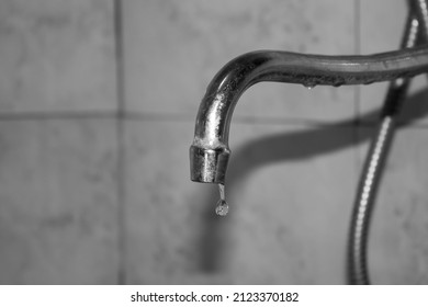 The A Drop Of Water From A Tap Black And White. Old Dirty Water Faucet.