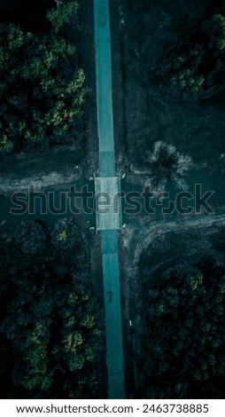 A dropdown view of a bridge with a stream going under it