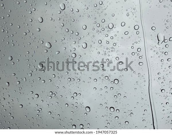 Droplet of\
water on car mirror with blur\
background
