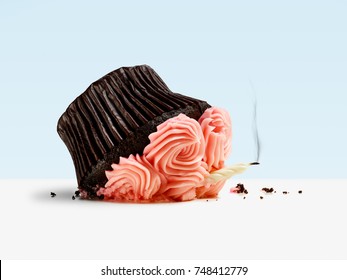 Dropped cupcake with candle and smoke on blue background